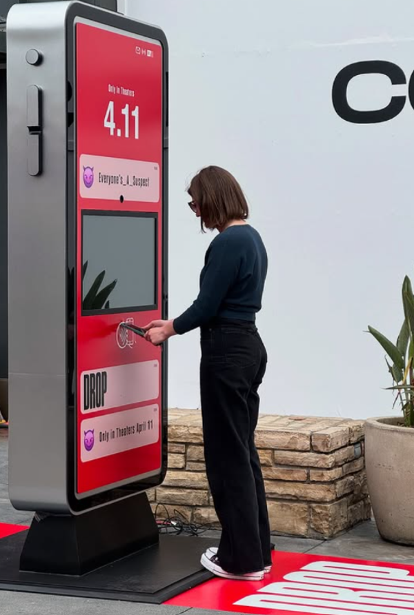 A visitor using the Drop promotional kiosk at a Universal Studios event.