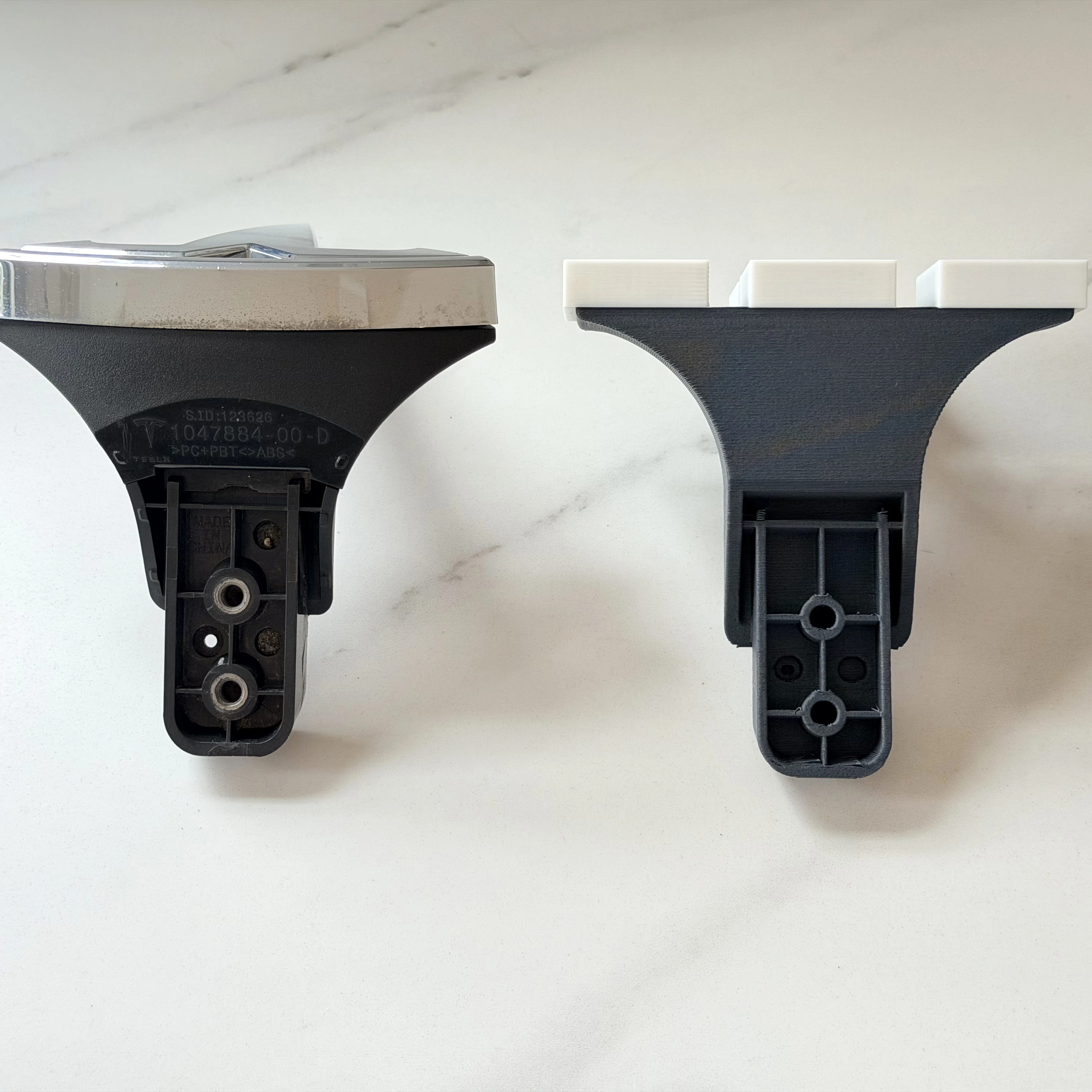 Parametric ergonomic hardware prototypes including Tesla emblems and bike accessories